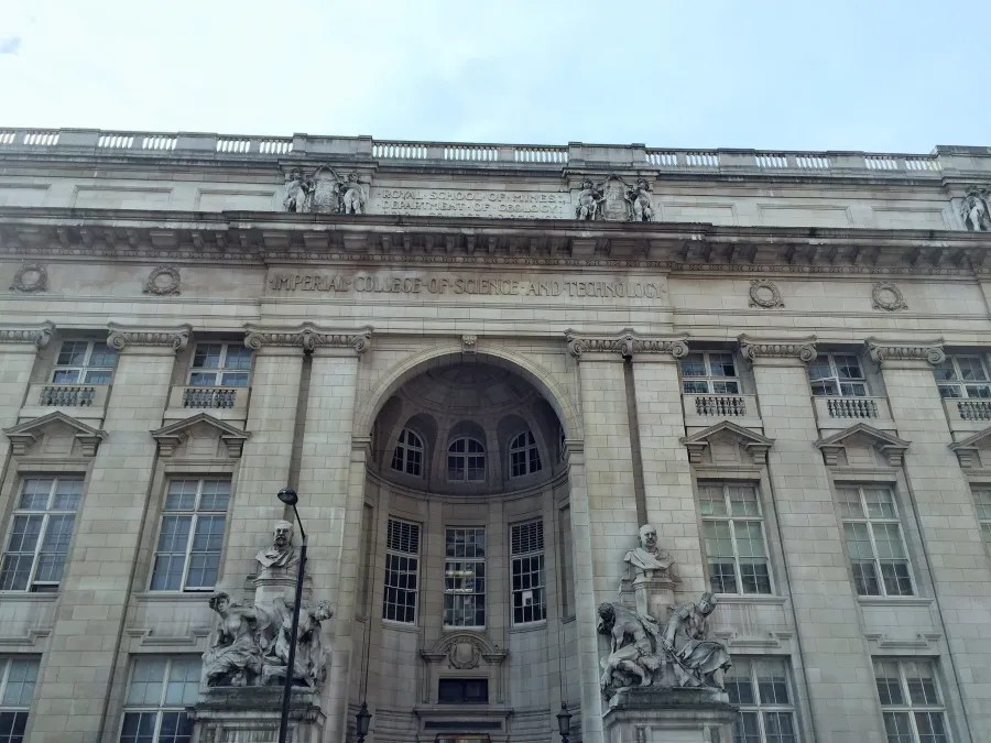 Frontansicht des Imperial College of Science, mit detaillierter Architektur und Figuren über dem Eingang.
