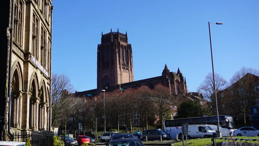 Blick auf die St. Lukes Kirche im Hintergrund und ein historisches Gebäude im Vordergrund an einem sonnigen Tag.