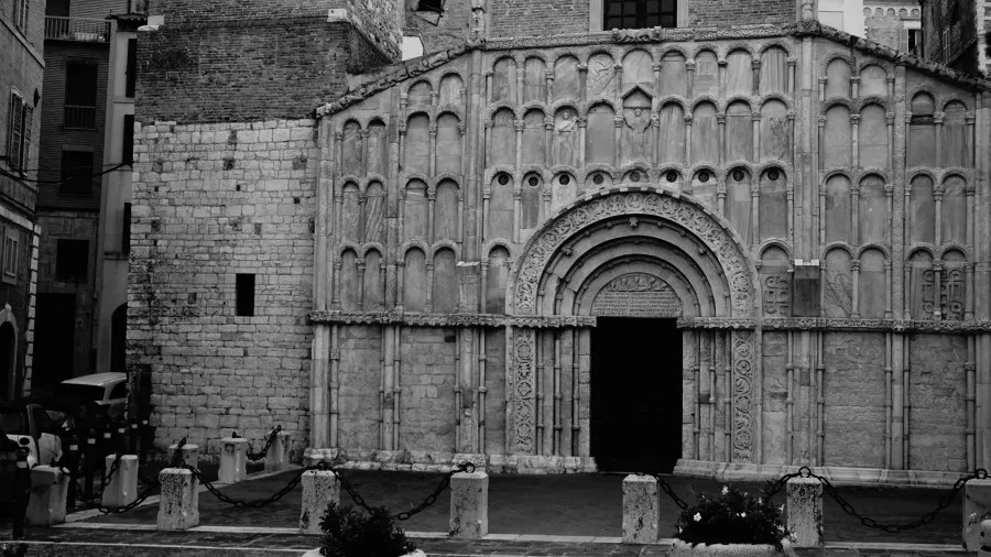 Ornate stone facade and arched entrance of a historic building with intricate carvings
