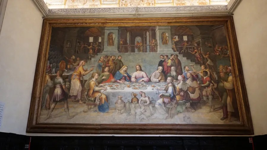Renaissance painting of a grand banquet with Jesus seated centrally among many guests and servants.