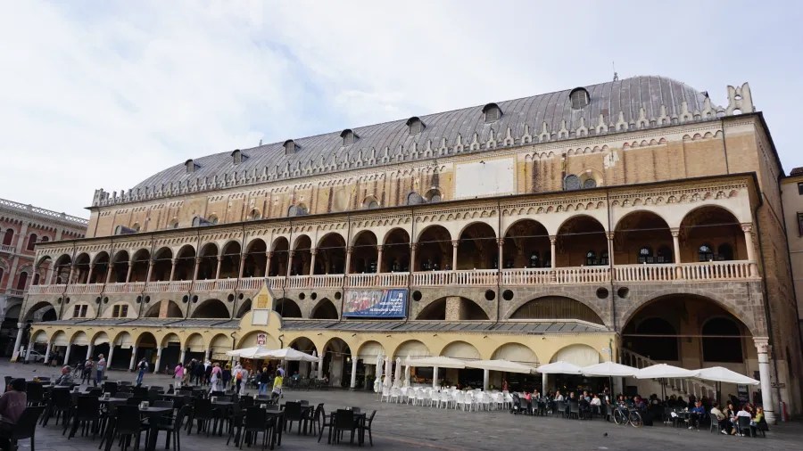 The Palazzo della Ragione in Padua featuring tiered arched loggias and a large vaulted roof.