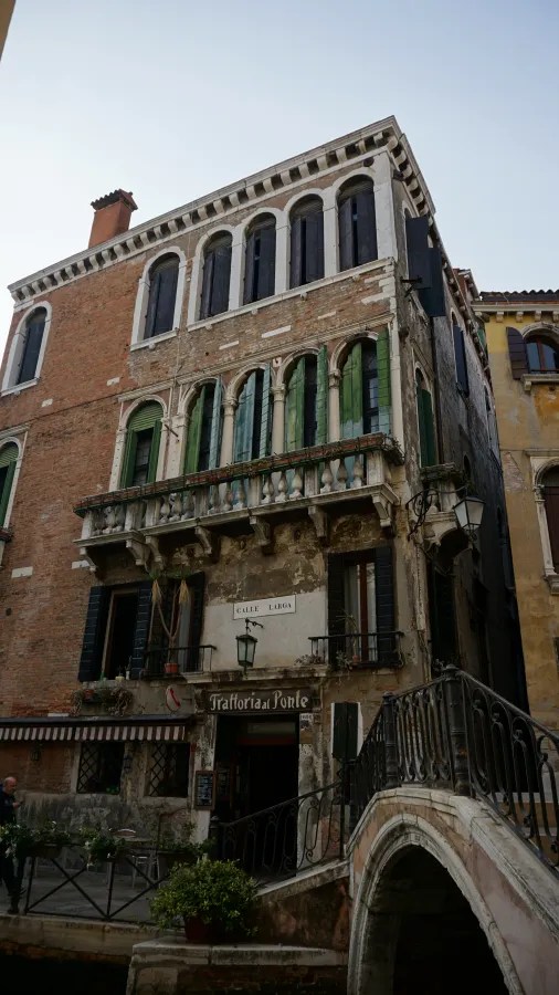 Trattoria al Ponte restaurant on Calle Larga in Venice, located beside a stone bridge.