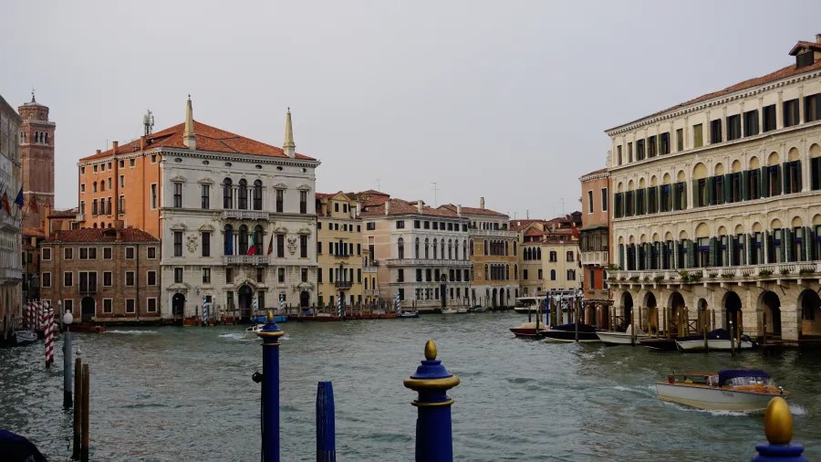 Grand Canal in Venice with historic buildings and boats under an overcast sky