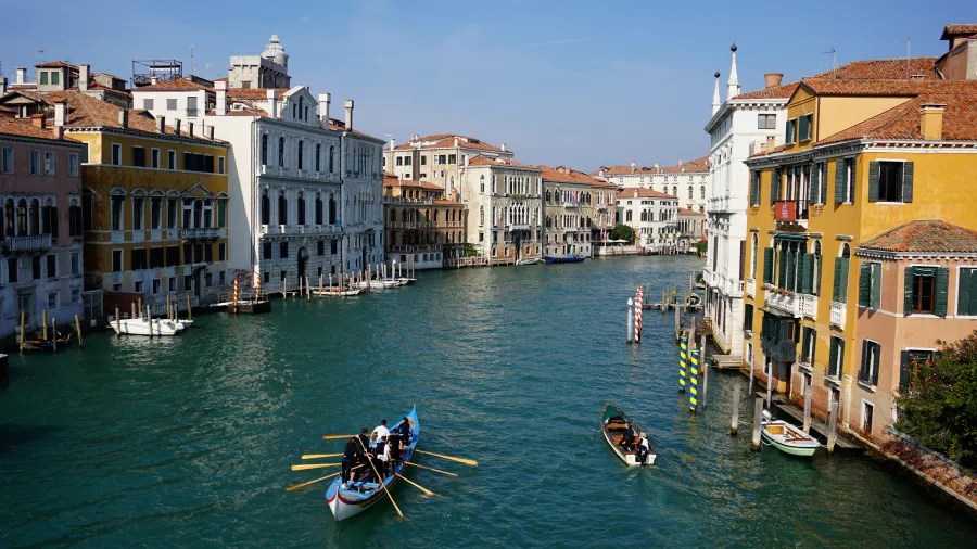 The Grand Canal in Venice with rowing boats and historic buildings along the waterway