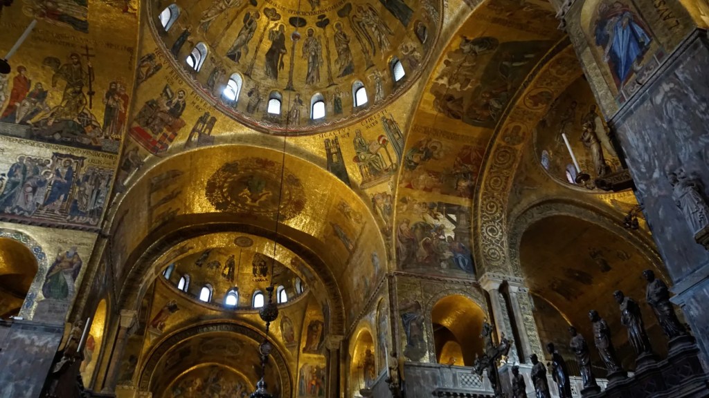 Intricate gold-ground mosaics covering the domes and arches of St. Mark's Basilica's interior