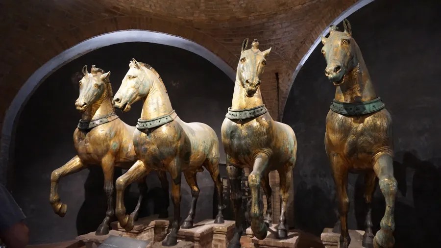 20221015_1_Italien_Venedig (57) Four gilded bronze horse sculptures, the Horses of Saint Mark, displayed in a vaulted room