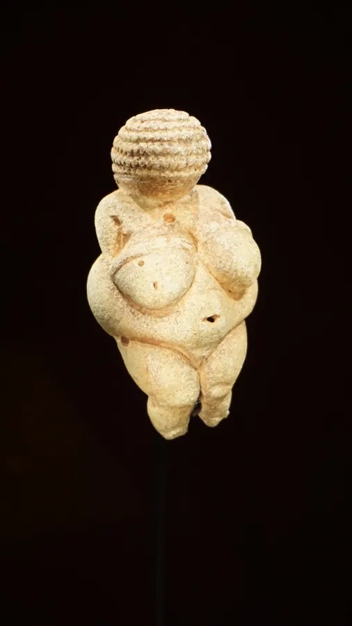 The Venus of Willendorf, a small Paleolithic figurine of a woman with exaggerated features