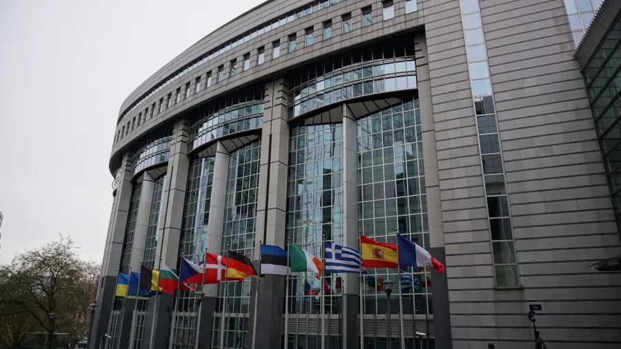 European Parliament building in Brussels with flags of member states and Ukraine flying.