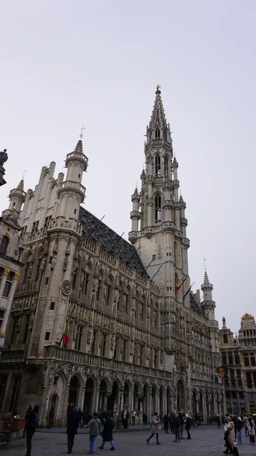 Gothic architecture of the Brussels Town Hall with its tall spire and ornate facade.