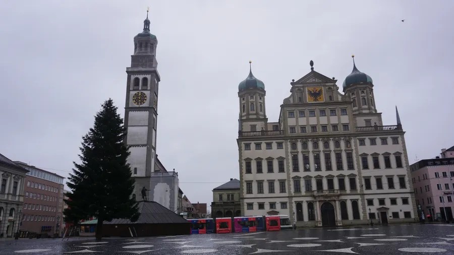Augsburg Town Hall and Perlach Tower in a city square with a large Christmas tree