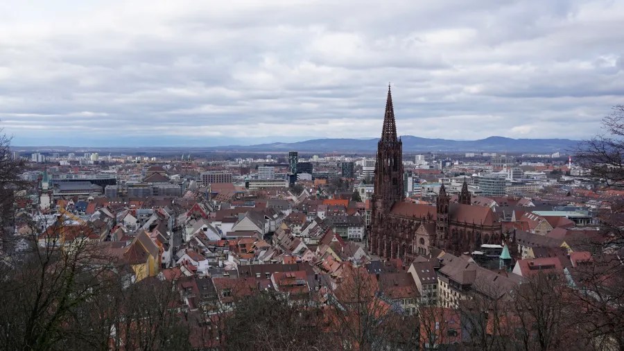 Elevated view of Freiburg cityscape featuring the tall spire of Freiburg Minster.