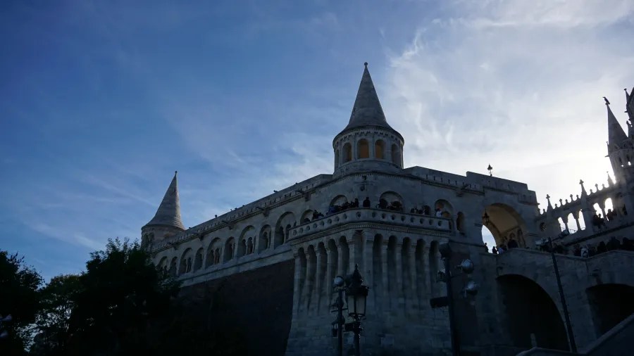 Arched stone balconies and conical spires of Fisherman's Bastion under a bright sky.