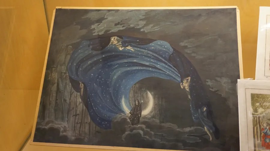 Figures holding a starry blue cloak over a figure seated on a crescent moon