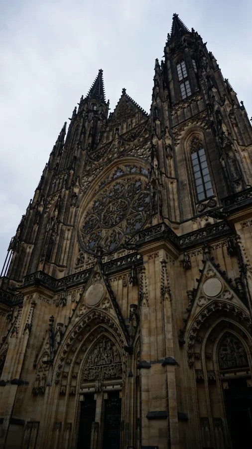 The Gothic facade and large rose window of St. Vitus Cathedral in Prague.
