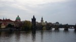 The Charles Bridge spanning the Vltava River with the historic Prague skyline in the background