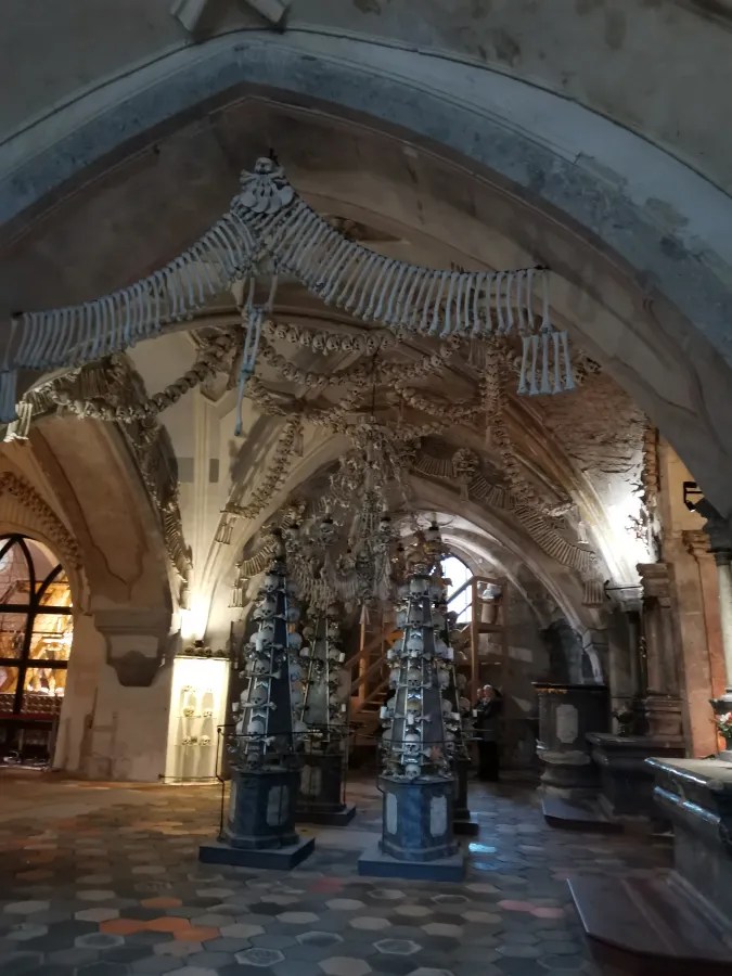 Interior of the Sedlec Ossuary featuring elaborate decorations and sculptures created from human bones and skulls.