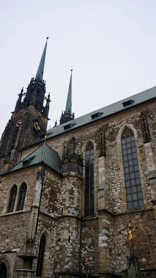 Gothic stone cathedral featuring tall, dark spires and narrow lancet windows.