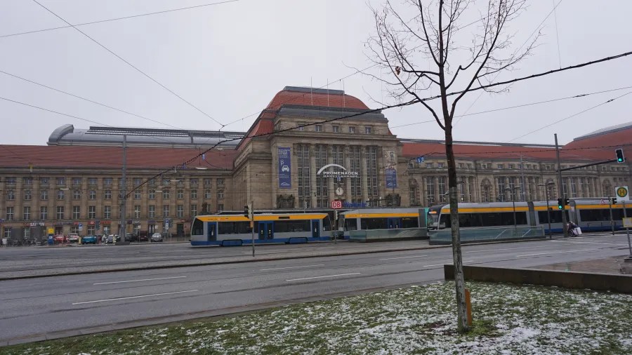 Leipzig Hauptbahnhof with 'PROMENADEN HAUPTBAHNHOF' and 'DB' signs and trams in the foreground