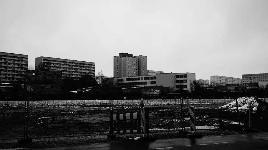 Black and white urban landscape of a construction site with apartment buildings and a CHEMIE building.