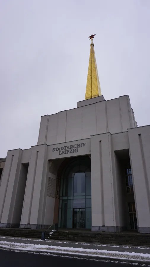 STADTARCHIV LEIPZIG building featuring a tall golden spire topped with a red star