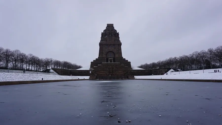 The Monument to the Battle of the Nations in Leipzig overlooking a frozen reflecting pool.