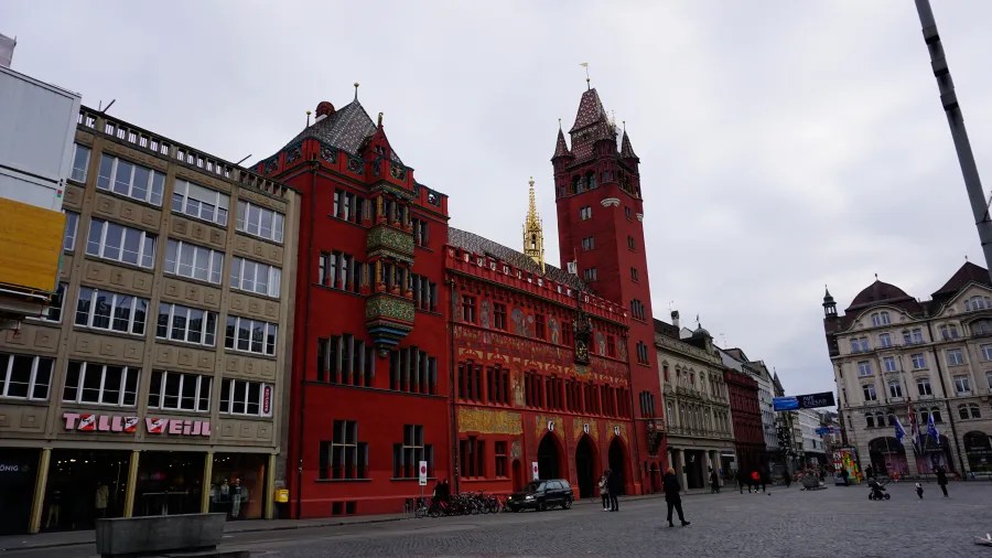 Historic red Rathaus building and city square in Basel, Switzerland