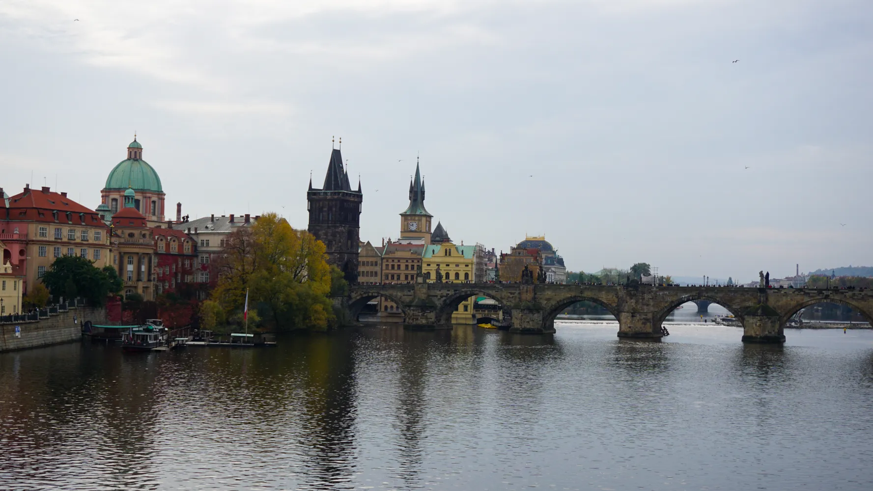 Charles Bridge over Vltava River with historic buildings and towers in Prague